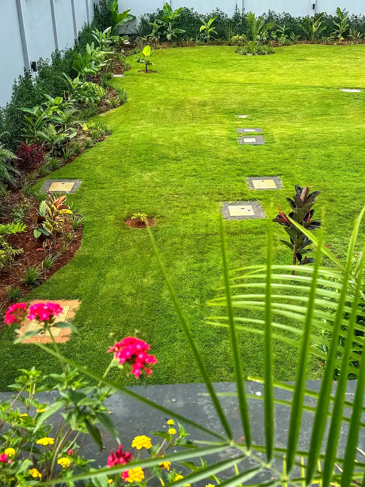 Flowering accents and foliage beside the lawn.